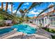 Backyard featuring a sparkling pool, spa, lush landscaping, and outdoor seating area for relaxation and entertainment at 2909 Sterling Cove Dr, Las Vegas, NV 89128