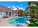 Backyard pool and spa surrounded by lush tropical landscaping, concrete patio, and house at 2909 Sterling Cove Dr, Las Vegas, NV 89128