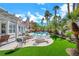 Backyard with pool, spa, pergola covered patio, and lush landscaping at 2909 Sterling Cove Dr, Las Vegas, NV 89128