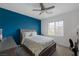 This bedroom features carpet flooring, blue accent wall, and a ceiling fan at 2951 Overlook Brook St, Las Vegas, NV 89156