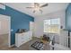 This bedroom features a blue accent wall, window and carpet flooring at 2951 Overlook Brook St, Las Vegas, NV 89156