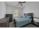 Bright bedroom features a ceiling fan, natural light from the window, and dark wood furniture at 2951 Overlook Brook St, Las Vegas, NV 89156