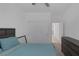Clean bedroom featuring white walls, a ceiling fan, double door closet, and dark wood furniture at 2951 Overlook Brook St, Las Vegas, NV 89156