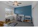 This is a bedroom with blue accent wall and a crib at 2951 Overlook Brook St, Las Vegas, NV 89156