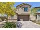 Charming two-story home with a well-maintained front yard and a two-car garage at 2951 Overlook Brook St, Las Vegas, NV 89156
