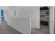 Hallway with carpet, a half wall, an open closet, and several entryways into other rooms at 2951 Overlook Brook St, Las Vegas, NV 89156