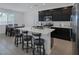 Contemporary kitchen features a large center island with seating, stainless appliances, and dark cabinetry at 2951 Overlook Brook St, Las Vegas, NV 89156