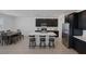 A modern kitchen shows a large island with seating and a view of the connected dining room area at 2951 Overlook Brook St, Las Vegas, NV 89156