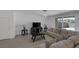 Comfortable living space with tiled floors, neutral tones, and sliding glass doors to the backyard at 2951 Overlook Brook St, Las Vegas, NV 89156