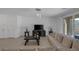 Relaxing living area features tile floors, neutral furniture, and sliding glass door for outdoor access at 2951 Overlook Brook St, Las Vegas, NV 89156
