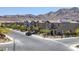 A street view of lovely two-story homes in the neighborhood, with mountain views at 2951 Overlook Brook St, Las Vegas, NV 89156