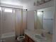 Bathroom with a tub and shower combination, a sink, and a mirror at 3024 Nutwood St, Las Vegas, NV 89108