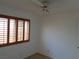 Bedroom with a ceiling fan and shuttered window at 3024 Nutwood St, Las Vegas, NV 89108