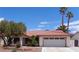 Charming single-story home features a tile roof, mature landscaping, and an attached two-car garage at 3024 Nutwood St, Las Vegas, NV 89108