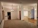 Open-concept space with carpet, neutral walls and views into the kitchen at 3024 Nutwood St, Las Vegas, NV 89108