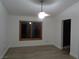 Bright living room features a ceiling fan, wood-look flooring and large window at 3024 Nutwood St, Las Vegas, NV 89108