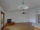 Open living room features hardwood floors, a fireplace, and a ceiling fan, complemented by the room's bright, airy atmosphere at 3024 Nutwood St, Las Vegas, NV 89108