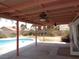Covered patio with dual ceiling fans overlooks the pool and backyard; perfect for enjoying outdoor living at 3024 Nutwood St, Las Vegas, NV 89108