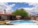 Inviting backyard pool area with a covered patio, perfect for outdoor relaxation and entertainment at 3024 Nutwood St, Las Vegas, NV 89108