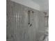 Shower with unique granite walls, vintage shower head, and decorative block at 3024 Nutwood St, Las Vegas, NV 89108