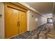 Long hallway with neutral colors and patterned carpet leading to unit entrance at 3111 Bel Air Dr # 18B, Las Vegas, NV 89109
