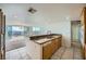 Bright kitchen featuring granite counters, tile floors, and a view of the balcony at 3111 Bel Air Dr # 18B, Las Vegas, NV 89109