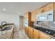 Cozy kitchen with wooden cabinets, granite countertops, and modern appliances at 3111 Bel Air Dr # 18B, Las Vegas, NV 89109
