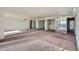 Spacious living room showcasing large mirror accents and balcony access at 3111 Bel Air Dr # 18B, Las Vegas, NV 89109