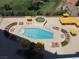 Aerial view of a sparkling community pool surrounded by lounge chairs and cabanas at 3111 Bel Air Dr # 18B, Las Vegas, NV 89109