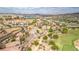 A high angle aerial view showing homes nestled into the Nevada landscape with a golf course and water feature at 32 Cerchio Basso, Henderson, NV 89011