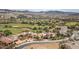 An aerial view of a desert community showing homes, landscaping, a golf course, and distant mountains at 32 Cerchio Basso, Henderson, NV 89011