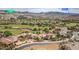 An aerial view of a Nevada community showing homes, golf course, desert landscape, location pin, and community names at 32 Cerchio Basso, Henderson, NV 89011