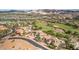 An aerial view of a desert community with mature landscaping, a golf course, and distant mountains at 32 Cerchio Basso, Henderson, NV 89011