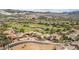 Aerial view of a community displaying homes, landscaping, a golf course, and distant mountains at 32 Cerchio Basso, Henderson, NV 89011