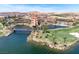 Stunning aerial view of a lakeside resort with lush landscaping and picturesque architecture against a mountain backdrop at 32 Cerchio Basso, Henderson, NV 89011