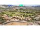 Aerial view of a community displaying homes, landscaping, a golf course, mountains, and community and hotel names at 32 Cerchio Basso, Henderson, NV 89011