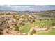 Community aerial view showcasing lush landscaping, elegant homes, and the scenic golf course at 32 Cerchio Basso, Henderson, NV 89011