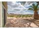 A home's back patio overlooks views of the Nevada landscape with a small decorative garden with small shrubs at 32 Cerchio Basso, Henderson, NV 89011