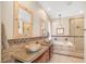 Luxurious bathroom with double vanities, soaking tub, and separate glass enclosed shower at 32 Cerchio Basso, Henderson, NV 89011
