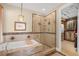 Elegant bathroom with soaking tub, glass enclosed shower, and access to a large walk-in closet at 32 Cerchio Basso, Henderson, NV 89011