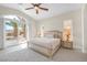 Bright bedroom with vaulted ceiling, ceiling fan, king bed and sliding glass doors to backyard patio at 32 Cerchio Basso, Henderson, NV 89011