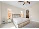Light and airy bedroom with neutral tones, ceiling fan, and decorative furniture at 32 Cerchio Basso, Henderson, NV 89011