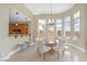 Bright dining room with large windows, modern chandelier, and access to the kitchen bar at 32 Cerchio Basso, Henderson, NV 89011