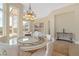 Elegant dining room with decorative round table and living room in the background at 32 Cerchio Basso, Henderson, NV 89011