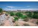 Scenic view of a lush green golf course from a hillside property overlooking mature trees at 32 Cerchio Basso, Henderson, NV 89011