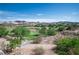 Scenic view of a lush green golf course from a hillside property overlooking mature trees at 32 Cerchio Basso, Henderson, NV 89011