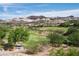 Picturesque view of the golf course, showcasing its well-maintained greens and the stunning mountain backdrop at 32 Cerchio Basso, Henderson, NV 89011