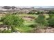 Scenic golf course view with lush green fairways surrounded by desert vegetation and distant mountains at 32 Cerchio Basso, Henderson, NV 89011