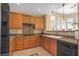 Well-lit kitchen with wood cabinets, granite counters, and modern appliances at 32 Cerchio Basso, Henderson, NV 89011
