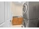 Modern laundry room featuring stacked washer and dryer units and a utility sink at 32 Cerchio Basso, Henderson, NV 89011